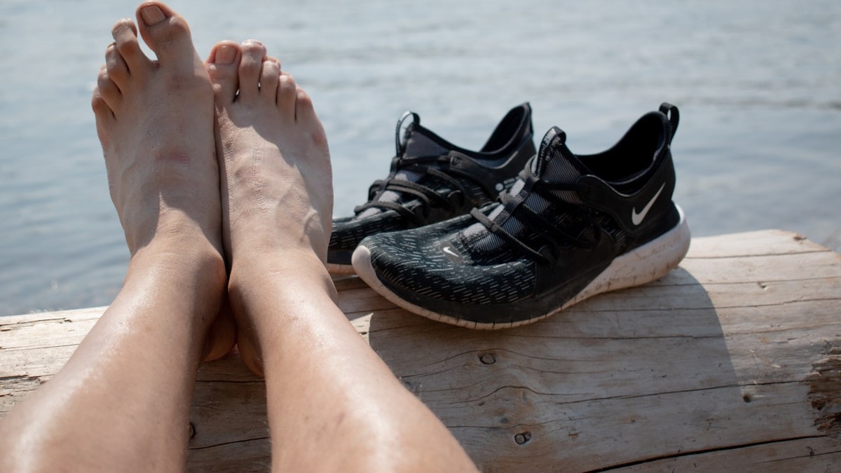 persons feet on brown wooden floor